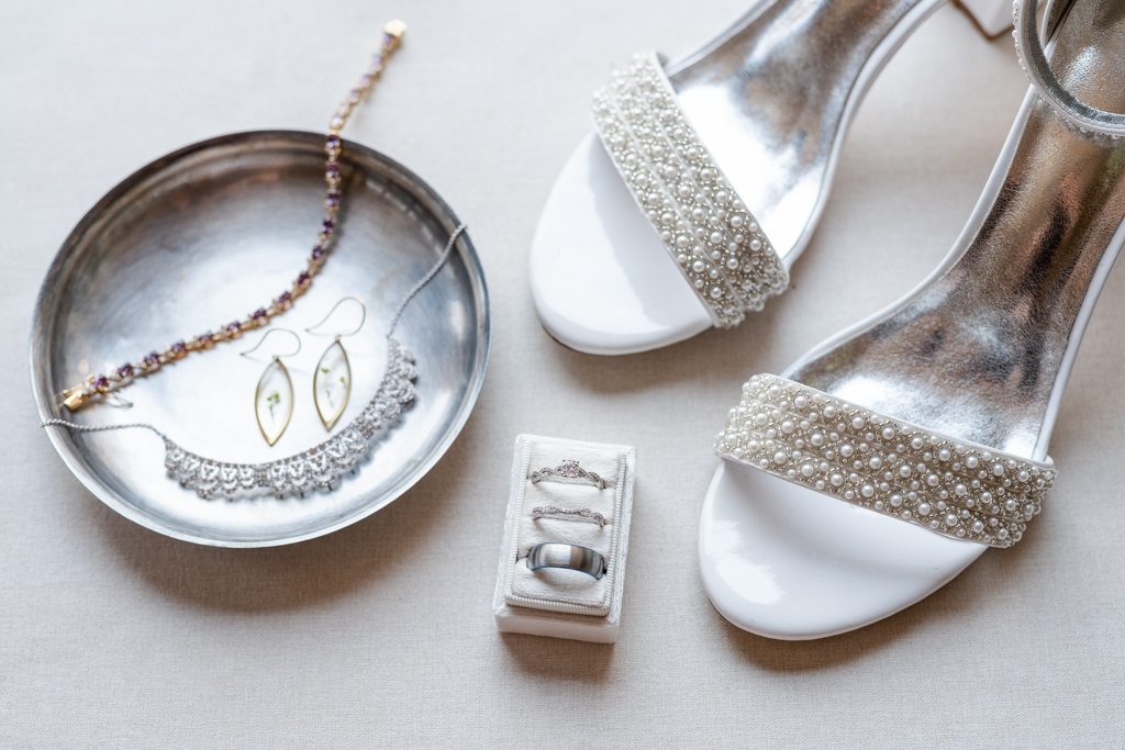 Bridal details including rings, necklace, earrings, bracelet and shoes
