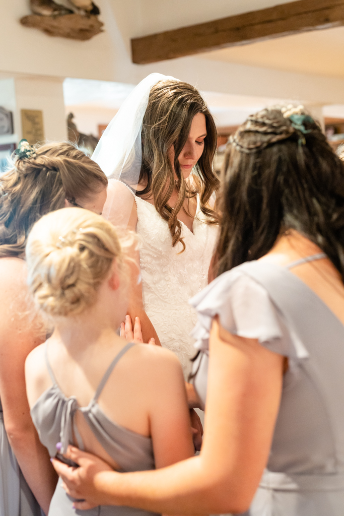 A moment of prayer with bride and bridesmaids at Foggy Bottom Farm in Hampstead, Maryland
