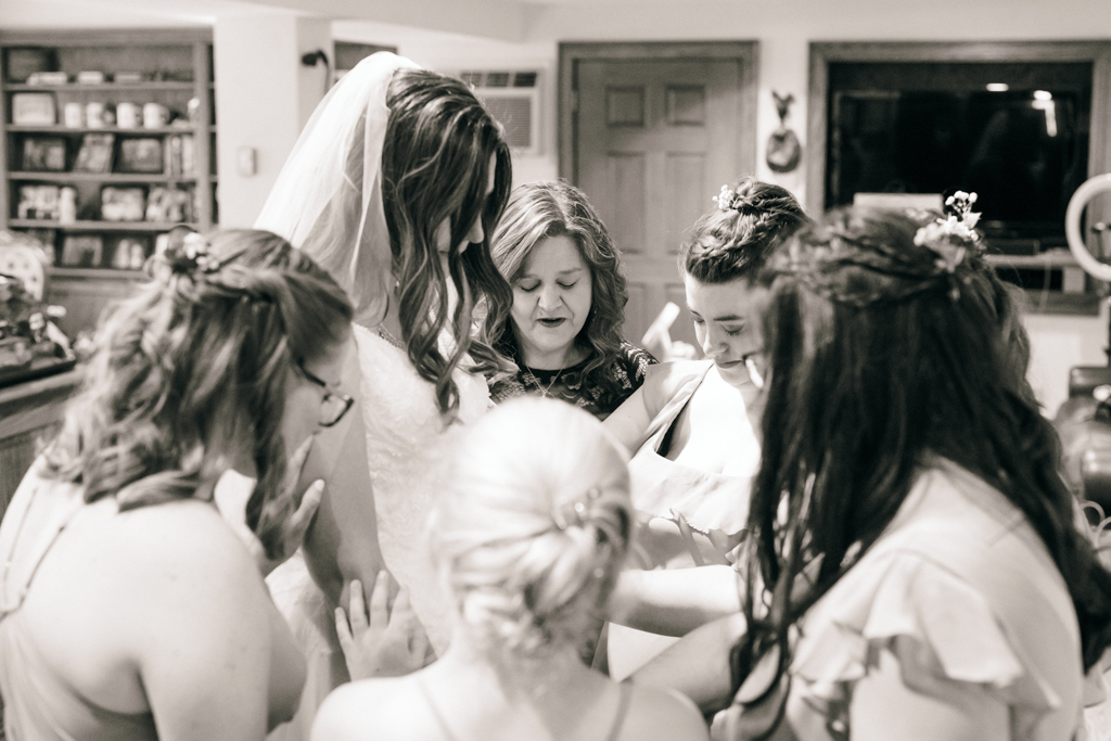 A moment of prayer with bride and bridesmaids at Foggy Bottom Farm in Hampstead, Maryland
