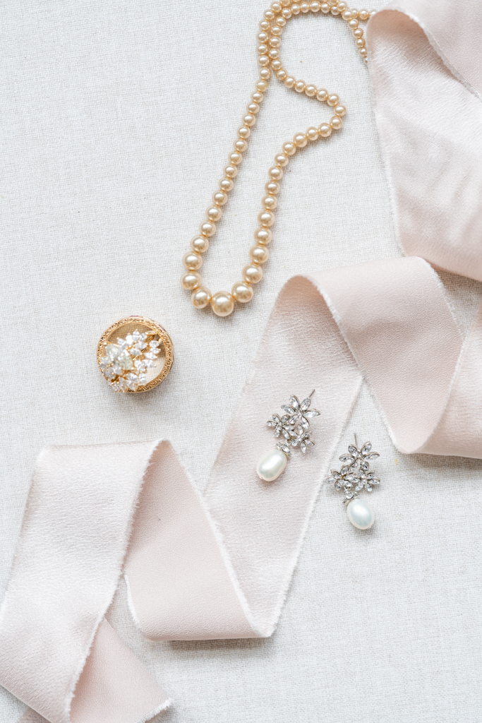 bridal details on wedding day with pearl earrings and necklace