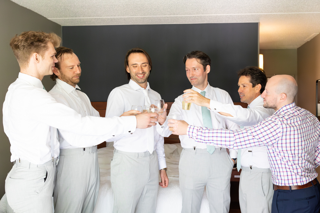 Groom getting ready with groomsmen on wedding day in Frederick, MD
