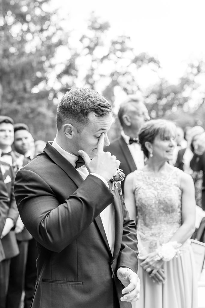 Groom crying during wedding ceremony on the lawn at the Mansion at Valley Country Club in Towson, MD