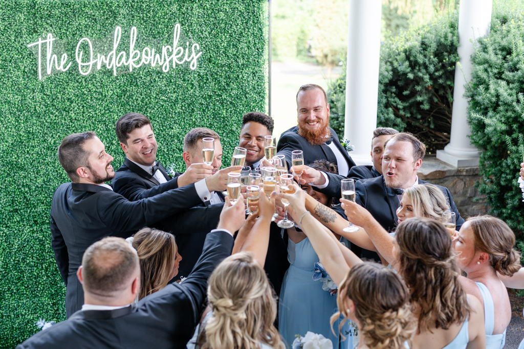 Wedding party cheersing to the newlyweds at the Mansion at Valley Country Club in Towson, MD