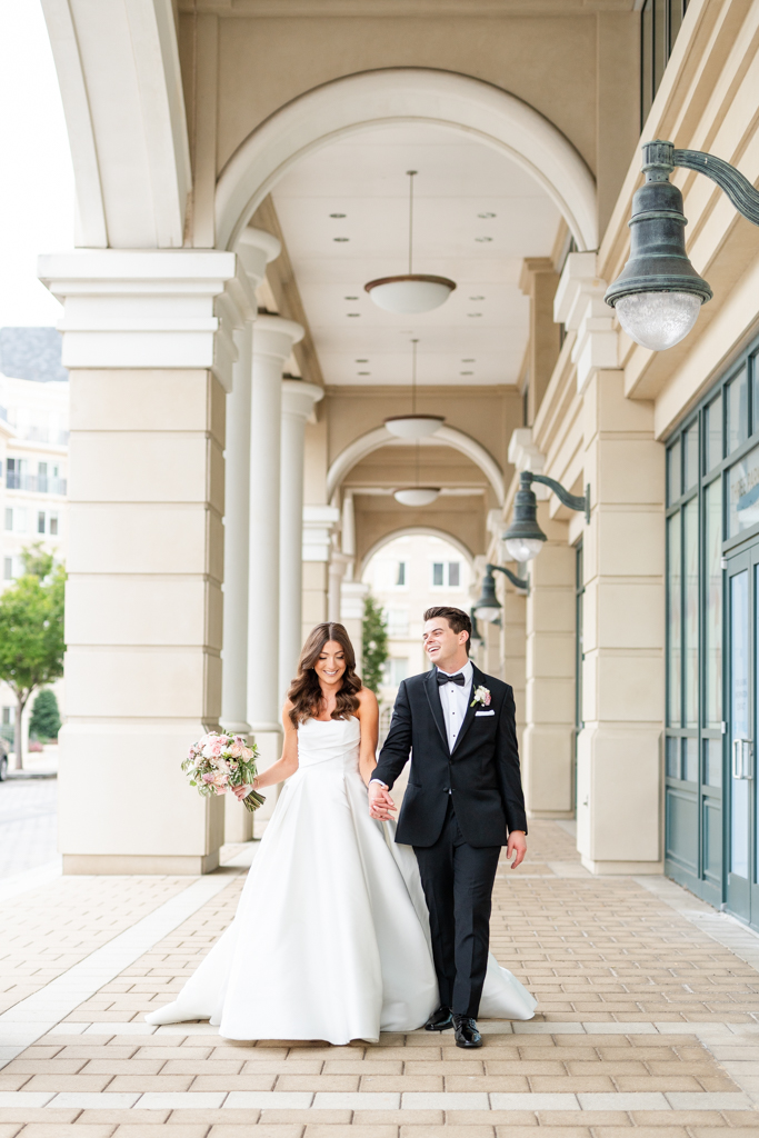 Bride and groom walking and laughing on their wedding day at The Westin Inn in Annapolis, Maryland