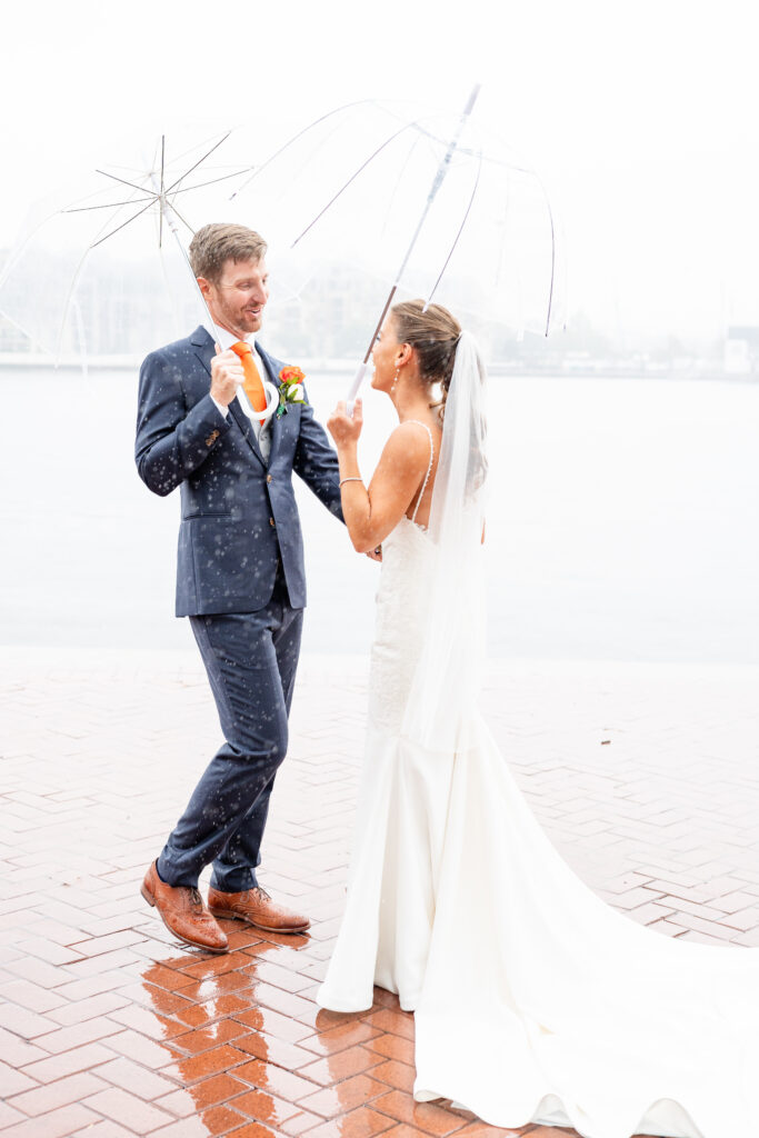 Bride and groom portrait at Baltimore Waterfront on a rainy wedding day