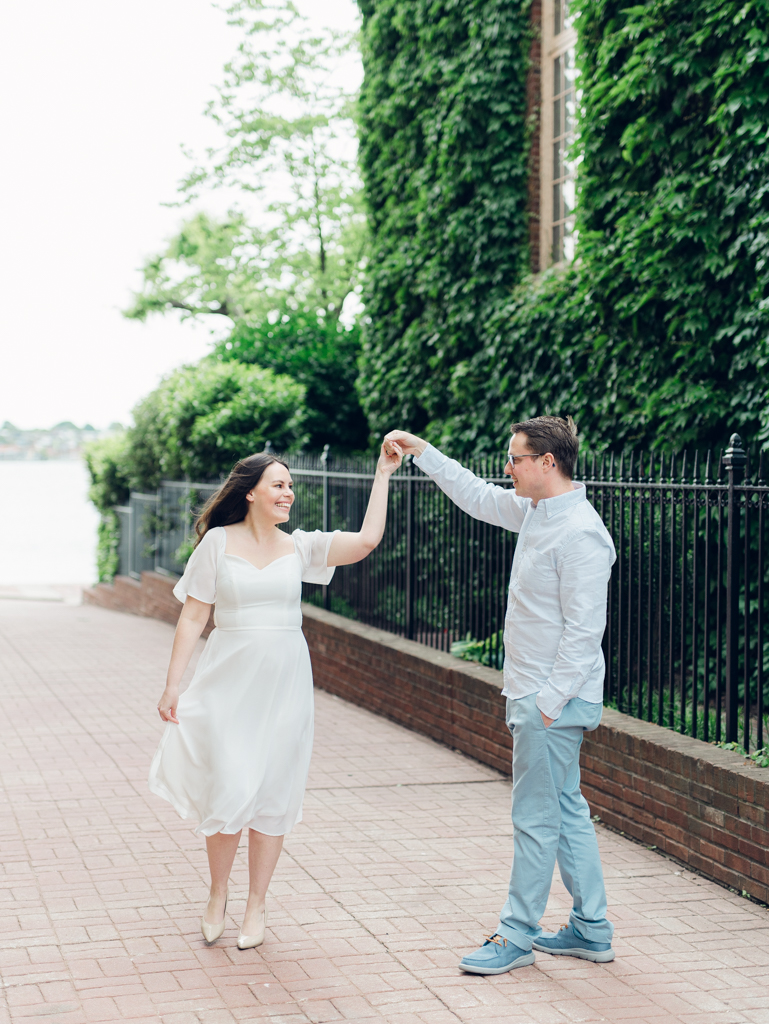 Engaged couple dancing in Fells Point for their Baltimore engagement session. 