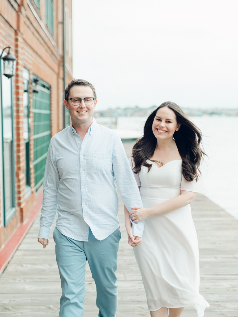 Engaged couple walking in Fells Point for their Baltimore engagement session. 