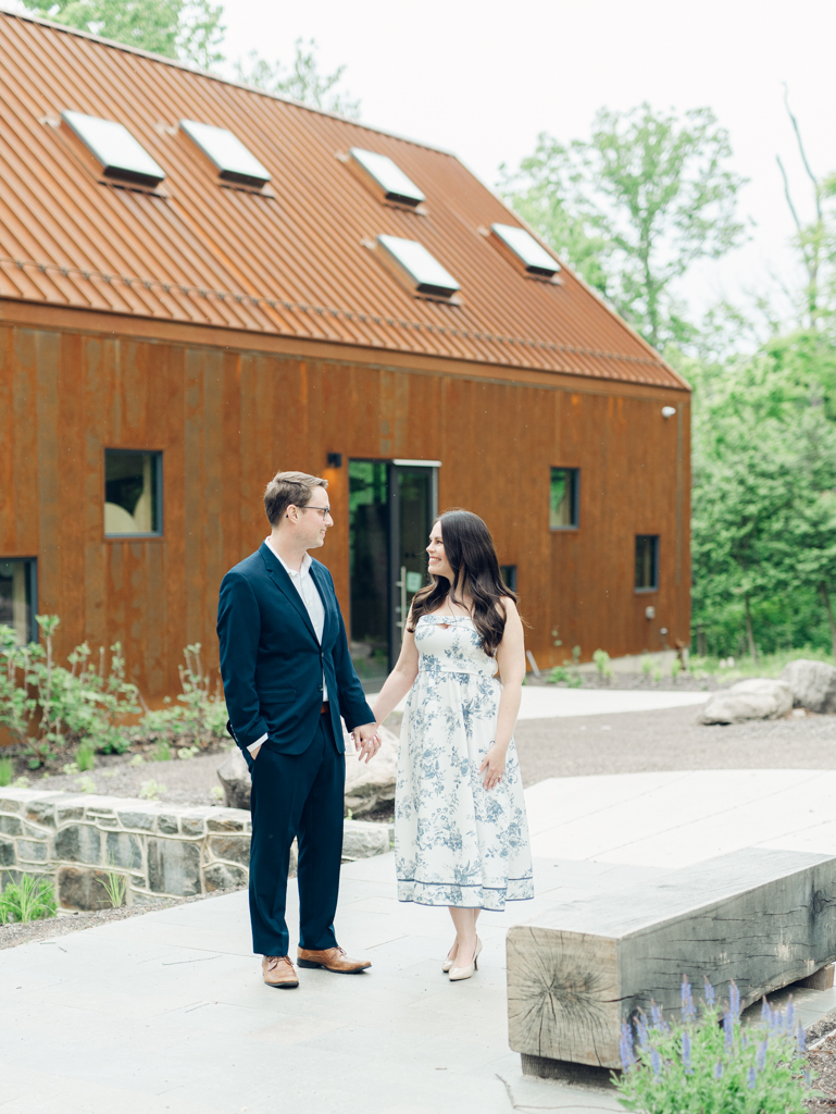 Engaged couple standing in front of Cylburn Nature Education Center for their Baltimore engagement session. 