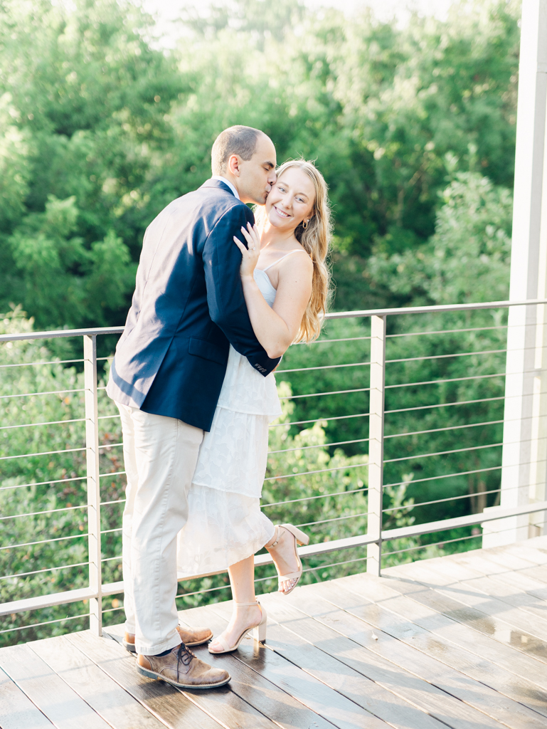 Mac kissing Abbey on the cheek during their engagement session at Howard County Conservancy