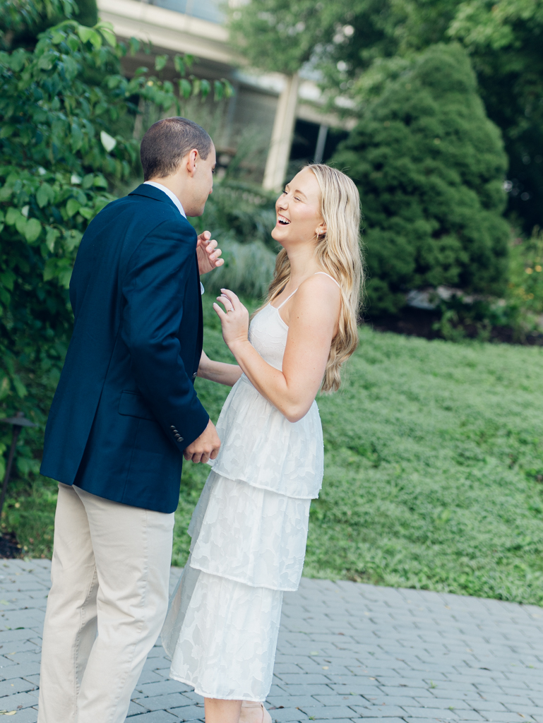 Mac and Abbey laughing during their engagement session at Howard County Conservancy