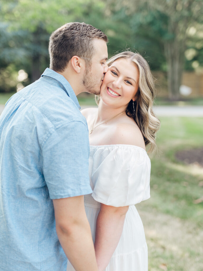 giovanni kissing Casey on the cheek at Bortner Valley during their engagement session