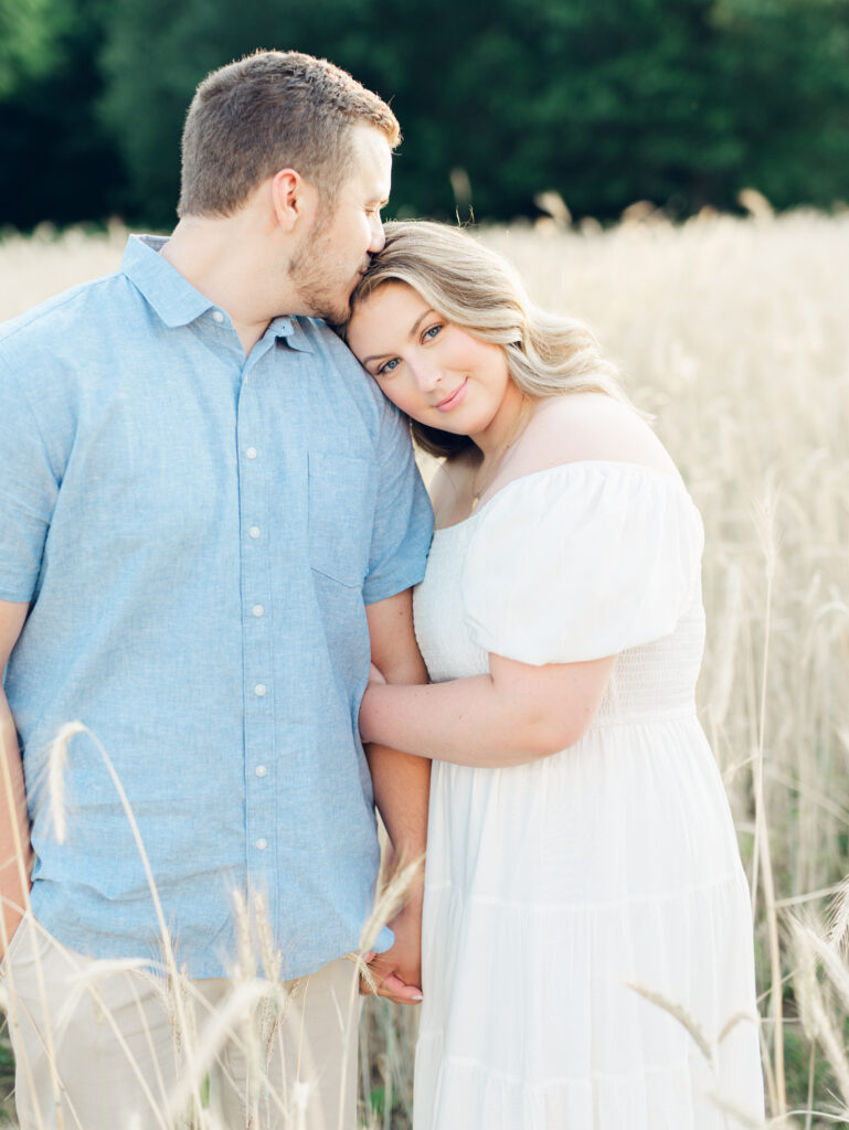 Casey and Giovanni laughing with each other in the fields at Bortner Valley during their engagement session