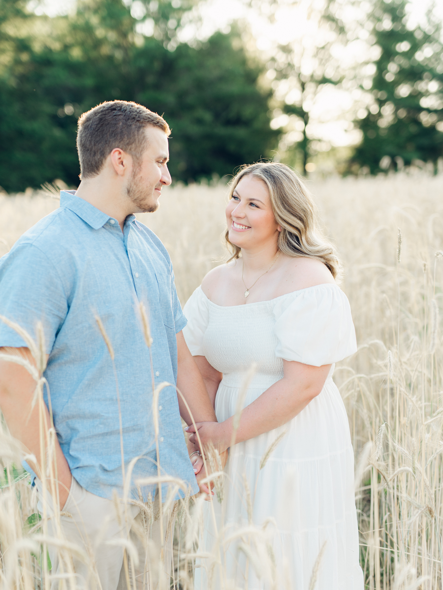 Casey and Giovanni laughing with each other in the fields at Bortner Valley during their engagement session