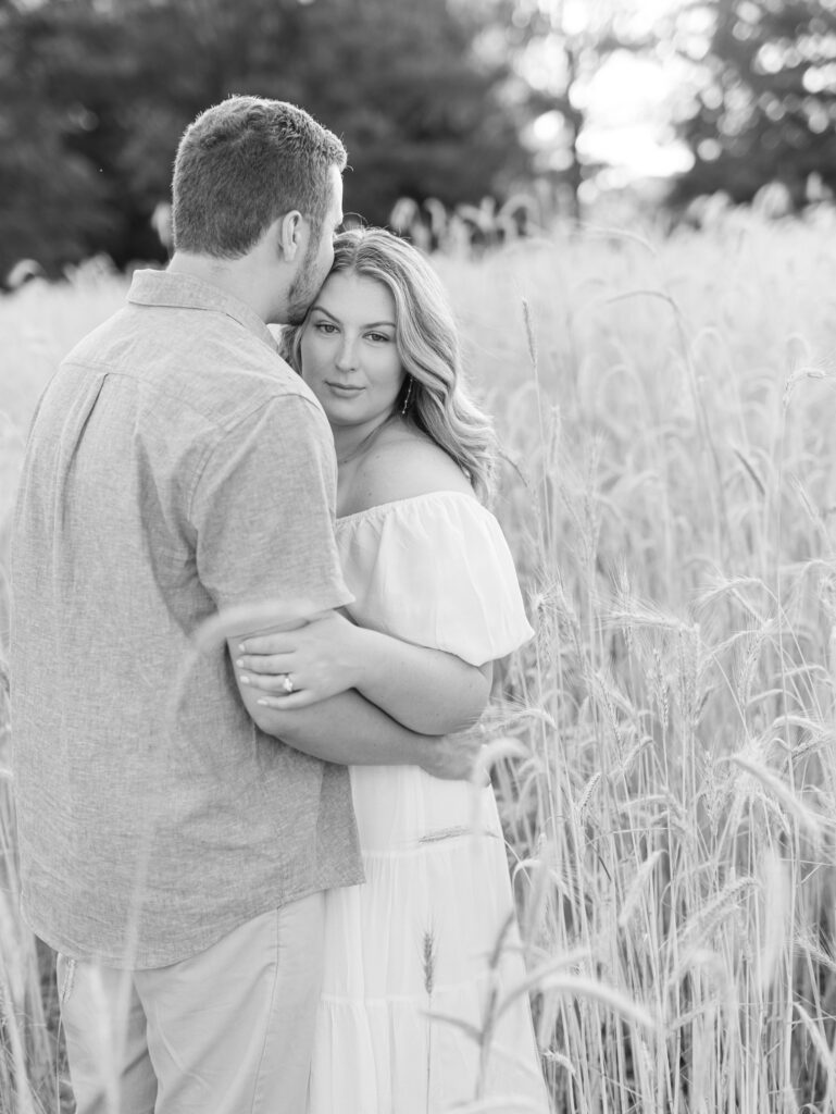 Casey and Giovanni hugging each other in the fields at Bortner Valley during their engagement session