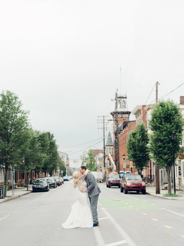 Amanda and Corey sharing a kiss in the street outside of The Bond Events on their wedding day.
