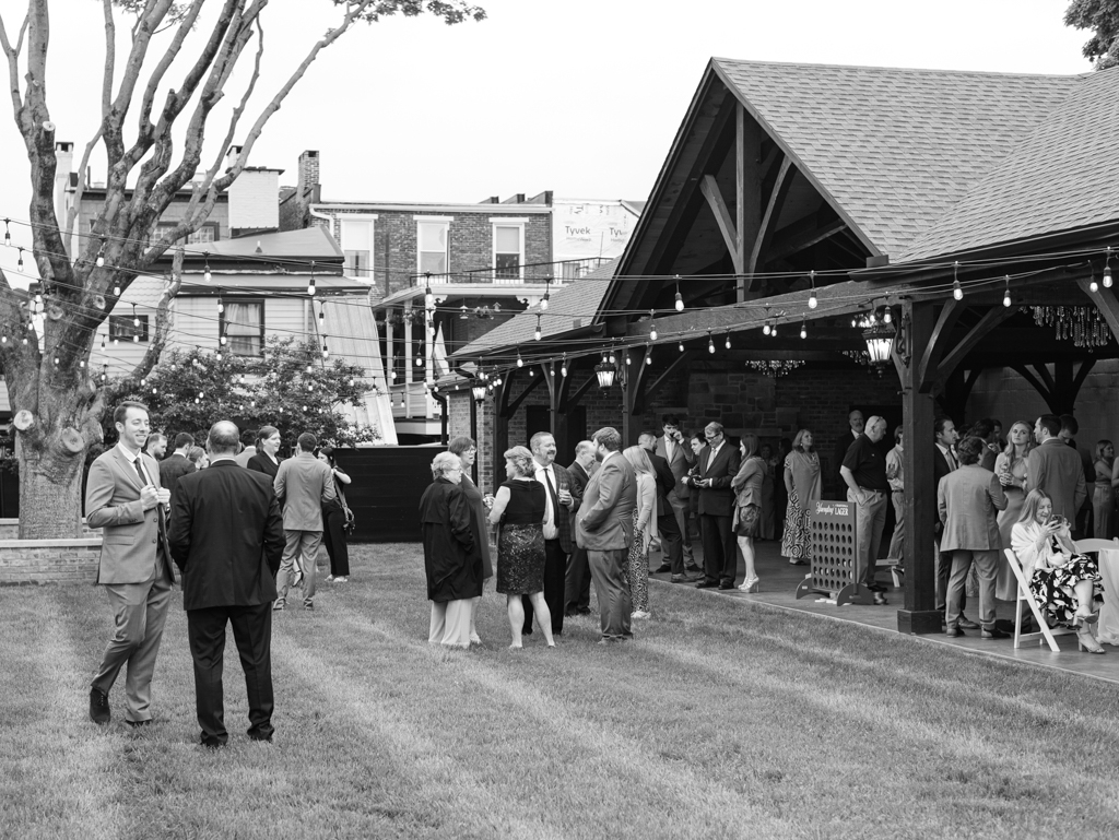 Guests interacting during cocktail hour in The Royal Square Gardens on Amanda and Corey's wedding day at The Bond Events.