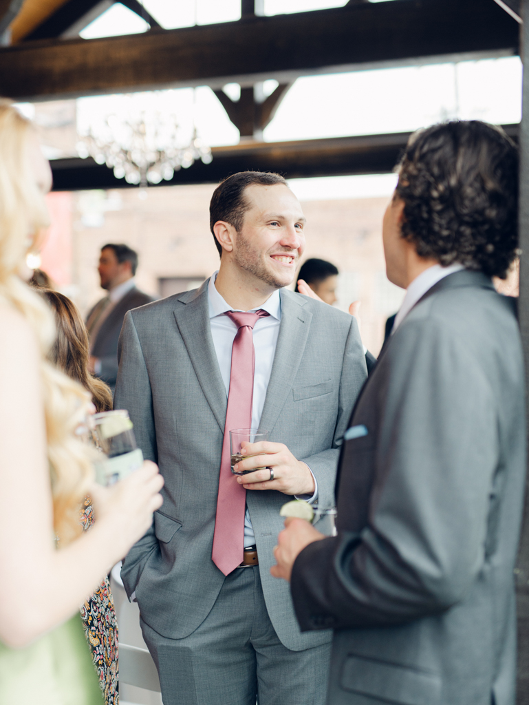 Guests interacting during cocktail hour in The Royal Square Gardens on Amanda and Corey's wedding day at The Bond Events.