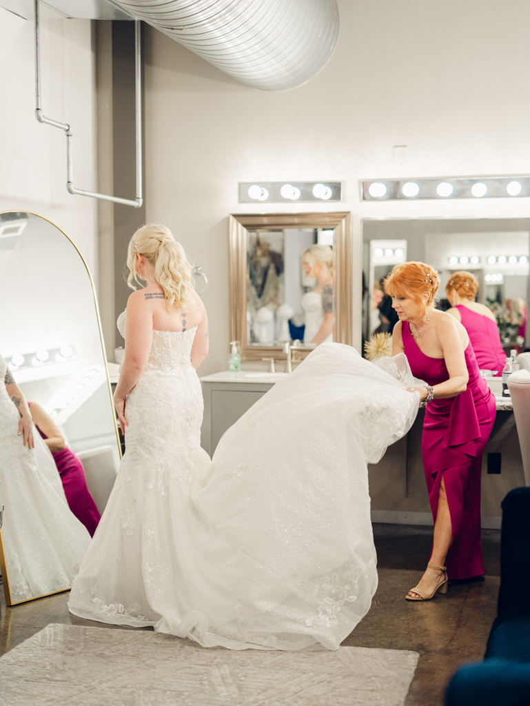 Amanda's mom helping her get dressed on her wedding day in the bridal suite at The Bond Events. 