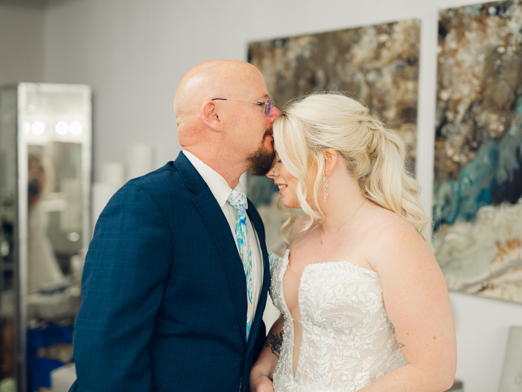 Amanda and her dad sharing a special moment together during their first look on her wedding day