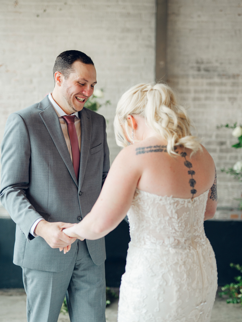 Corey smiling with Amanda during their first look inside The Bond Events. 