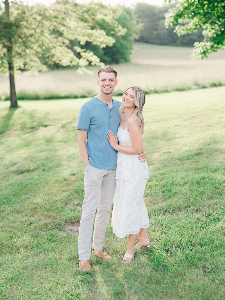 Victoria & Jacob smiling during golden hour for their engagement session at Cold Saturday Farm