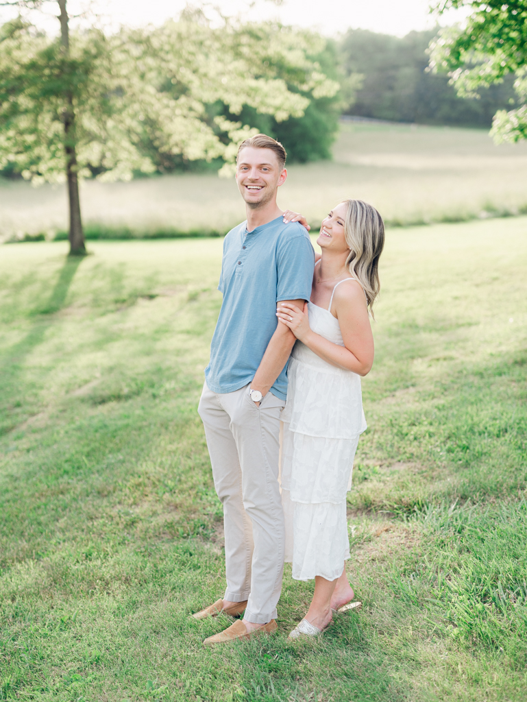 Victoria & Jacob laughing together during golden hour for their engagement session at Cold Saturday Farm