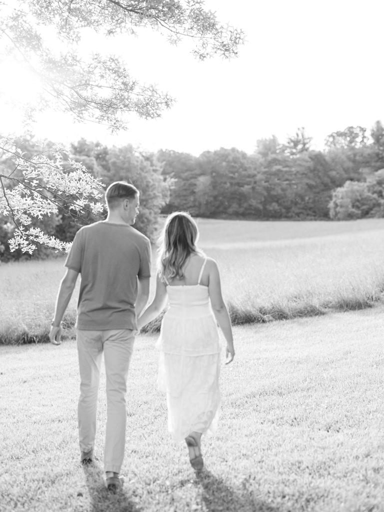 Victoria & Jacob walking off into the sunset during golden hour for their engagement session at Cold Saturday Farm