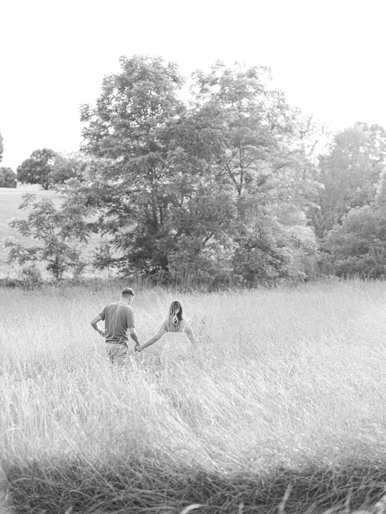 Victoria & Jacob running through the field during golden hour for their engagement session at Cold Saturday Farm