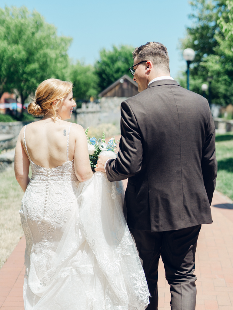 Anna and Sam taking portraits along Carroll Creek before their McClintock Distilling Wedding in Frederick, Maryland