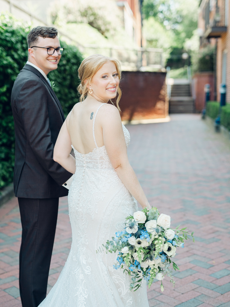 Anna and Sam taking portraits along Carroll Creek before their McClintock Distilling Wedding in Frederick, Maryland