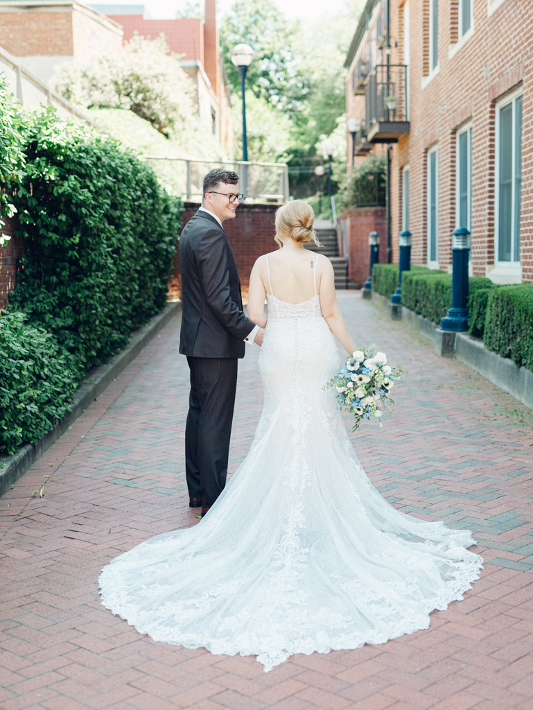 Anna and Sam taking portraits along Carroll Creek before their McClintock Distilling Wedding in Frederick, Maryland