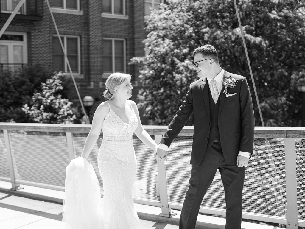 Anna and Sam taking portraits along Carroll Creek before their McClintock Distilling Wedding in Frederick, Maryland