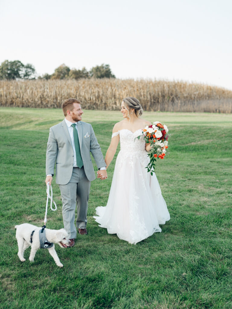 newlyweds including their dog in their wedding day portraits