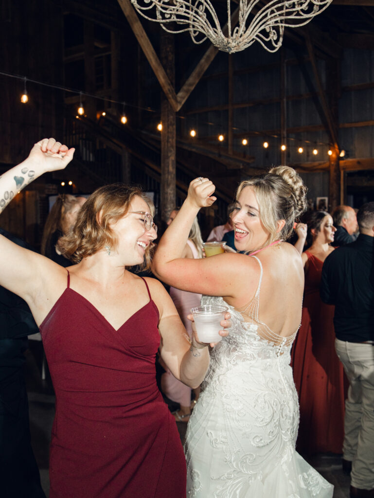 bride and guests dancing at wedding reception with glow sticks