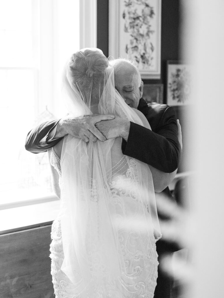 bride and dad hugging each other during a first look on her wedding day