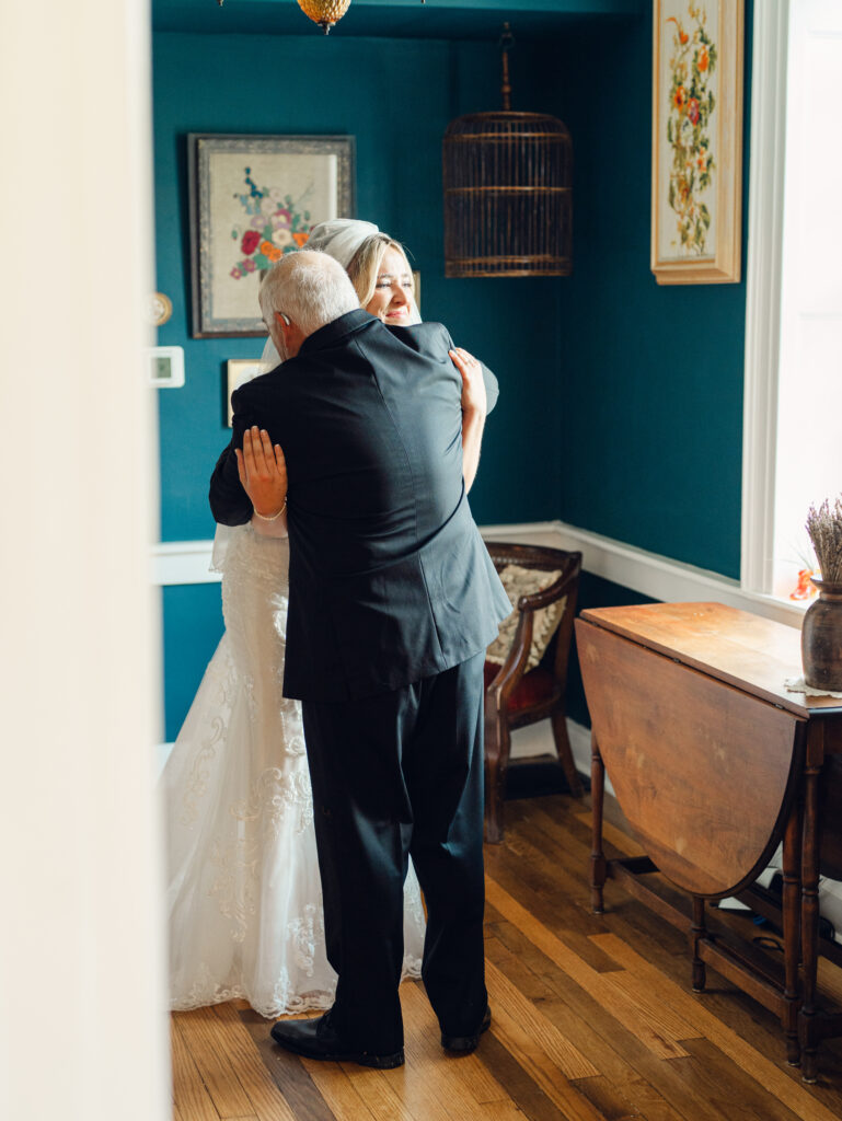 Bride first look with her dad on her wedding day, hugging her dad