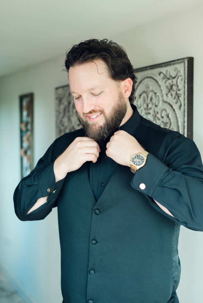 Jason fixing his bowtie getting ready for his wedding day at The Hummingbird Chateau in Manchester, MD