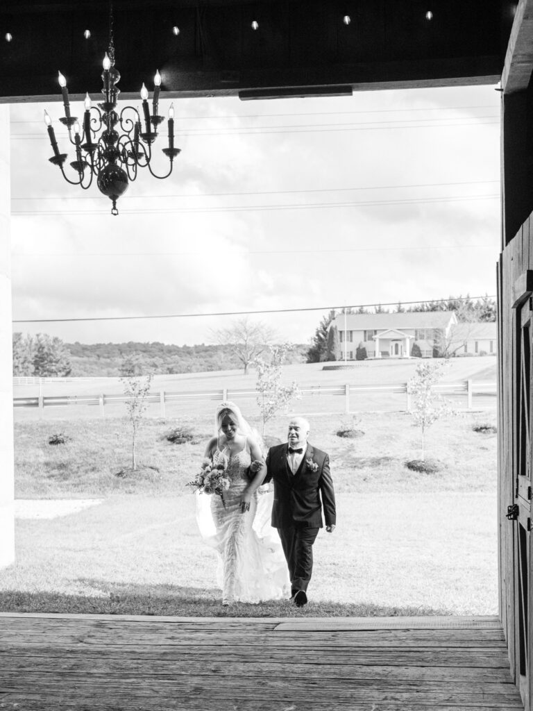 Bride walking with her dad into her wedding ceremony