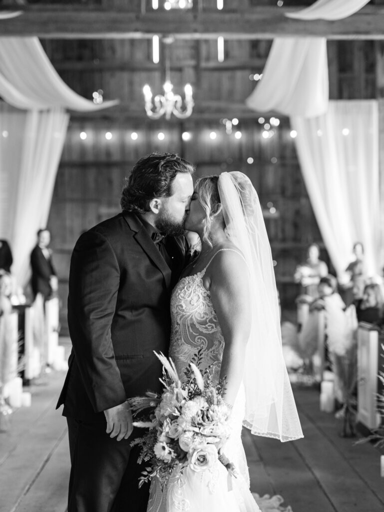 bride and groom kissing at the end of their wedding ceremony at The Hummingbird Chateau