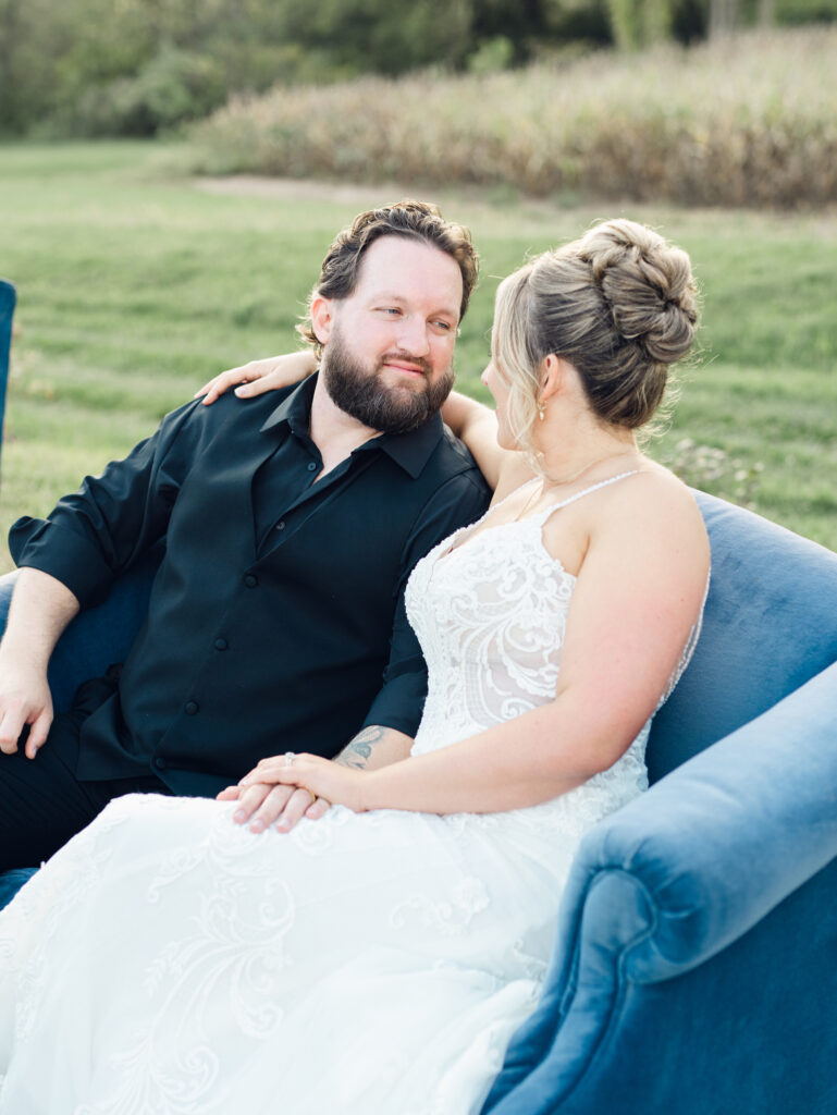 Bride and groom smiling and laughing with each other at The Hummingbird Chateau on their wedding day