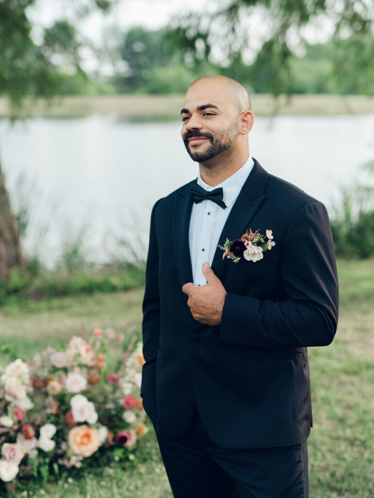 groom holding his tux on his wedding day