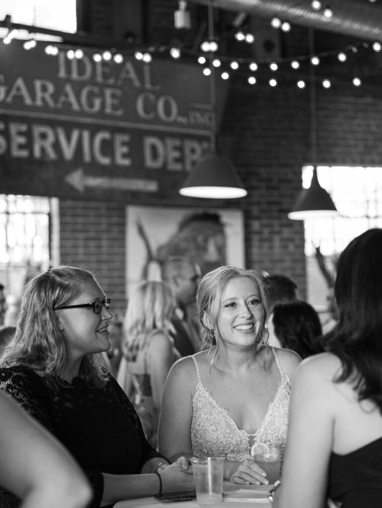 Anna enjoying chatting with her guests during cocktail hour during her McClintock Distilling Wedding