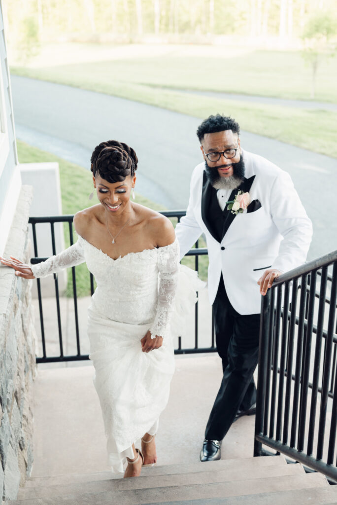 Courtney & Phil walking together smiling on their wedding day by a Baltimore, MD documentary style wedding photographer