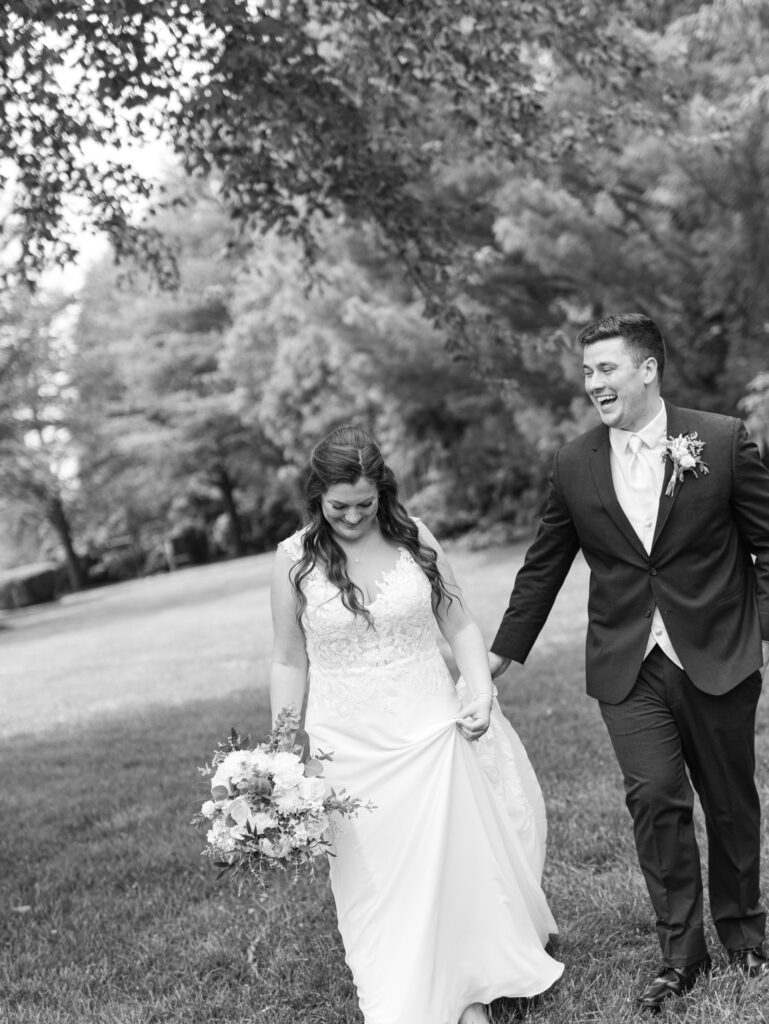 couple using their wedding photography timeline to laugh together while taking portraits on their wedding day