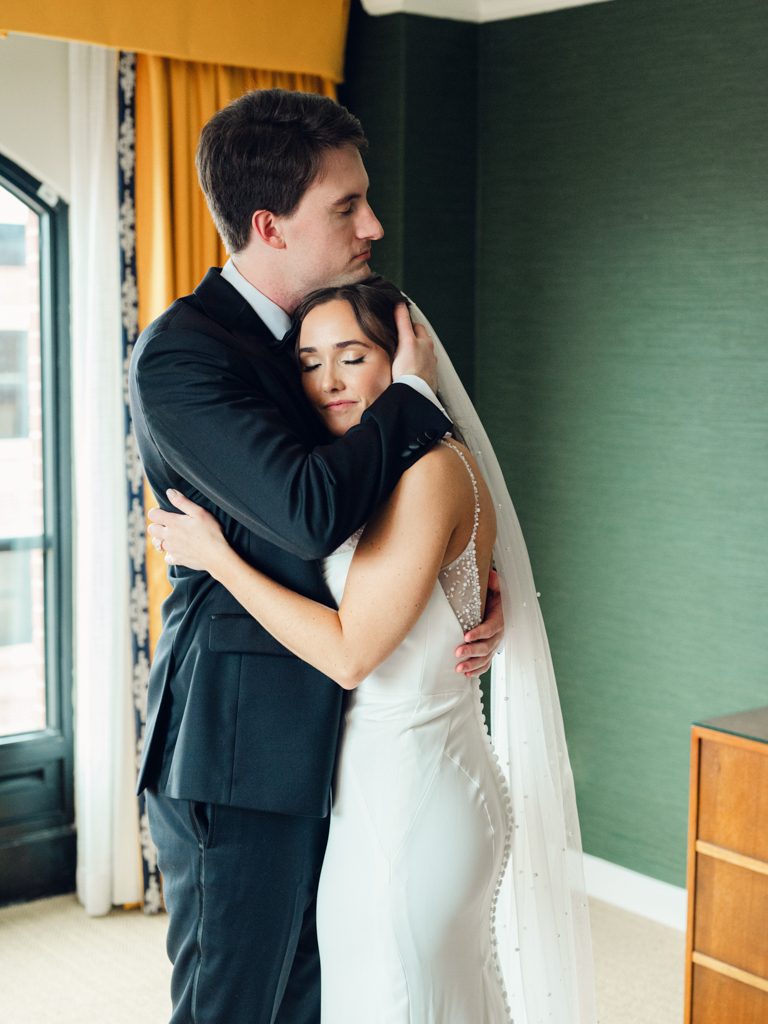 Bride and groom hugging after their first look at the Graduate Hotel Annapolis