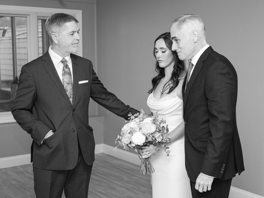 a quiet moment with the bride and her dad and stepdad before her wedding ceremony begins. 