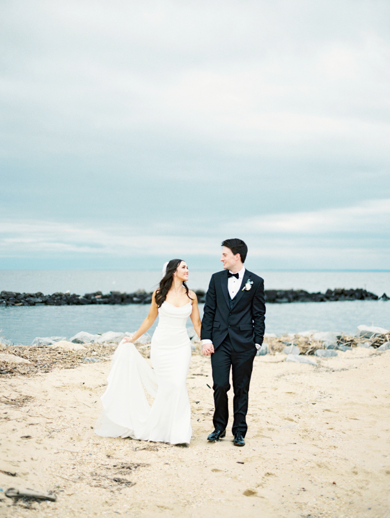 Bride and groom walking down the beach at Silver Swan bayside on their wedding day taken by film wedding photographer