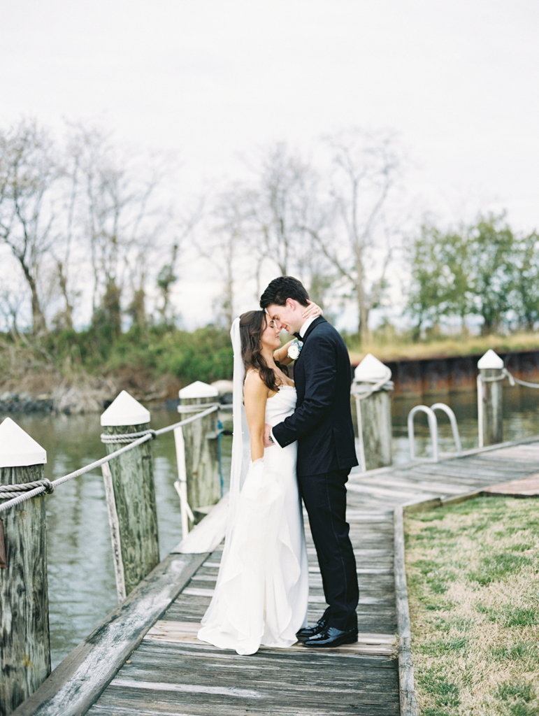 Bride and groom enjoying a quiet moment together on the boardwalk at Silver Swan bayside on their wedding day taken by film wedding photographer