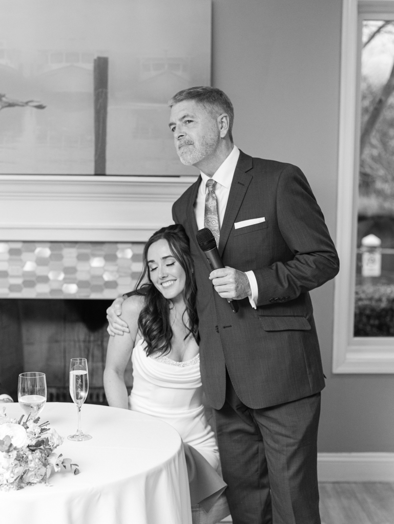 stepdad lovingly hugging bride during his toast on her wedding day at Silver Swan Bayside