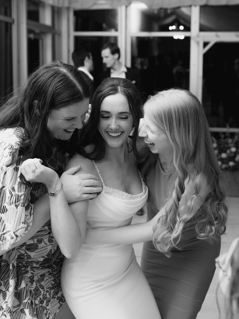 friends hugging the bride on her wedding day at Silver Swan Bayside